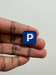 hand displaying pushin p enamel pin